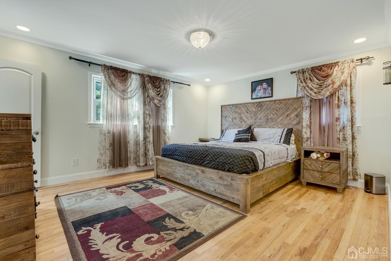 7 Colburn Road East Brunswick, NJ 08816 - Photo 16 of 25 a bedroom with a large bed and a mirror