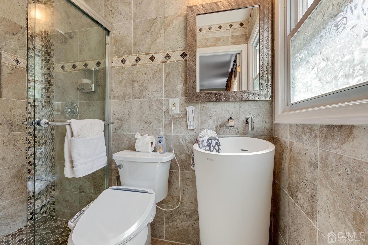 7 Colburn Road East Brunswick, NJ 08816 - Photo 17 of 25 a white toilet sitting next to a bathroom sink