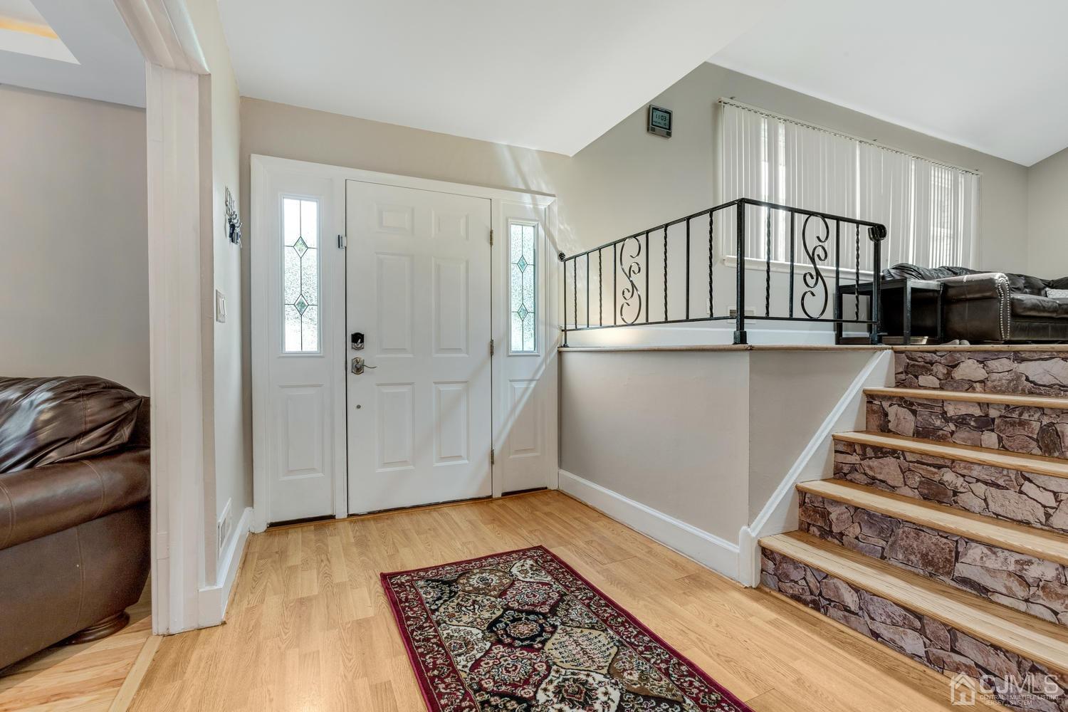 7 Colburn Road East Brunswick, NJ 08816 - Photo 4 of 25 a view of entryway with stairs and wooden floor