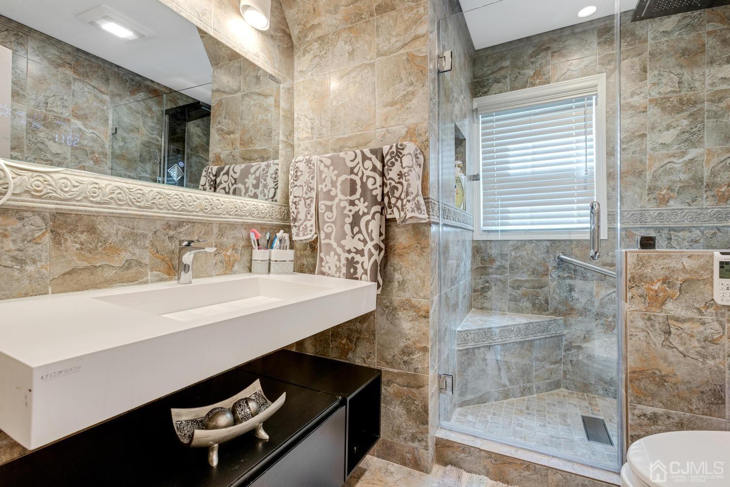 7 Colburn Road East Brunswick, NJ 08816 - Photo 8 of 25 a bathroom with a sink a toilet and shower