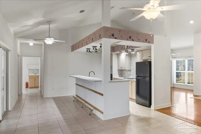 a view of a kitchen with a sink and a refrigerator
