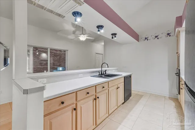 a kitchen with a sink and a large window
