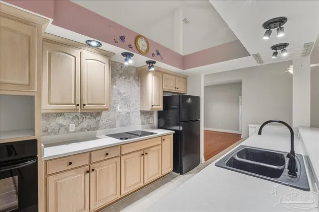 a kitchen with a sink and refrigerator