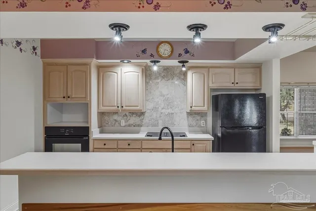 a kitchen with a refrigerator and a sink