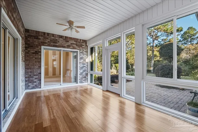 a view of an entryway with wooden floor and fence