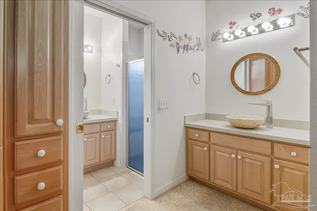 a bathroom with a granite countertop sink a mirror and a shower
