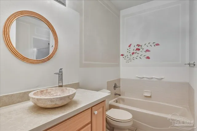 a bathroom with a toilet a sink and bathtub