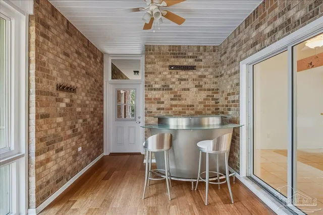 a dining room with furniture and wooden floor
