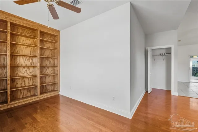 a view of a room with wooden floor and windows
