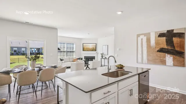 a kitchen with a sink cabinets and wooden floor