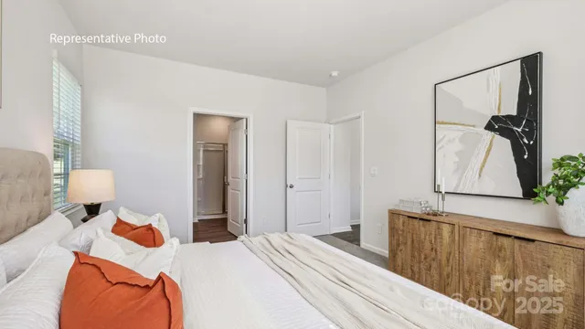 a bedroom with bed and wooden floor