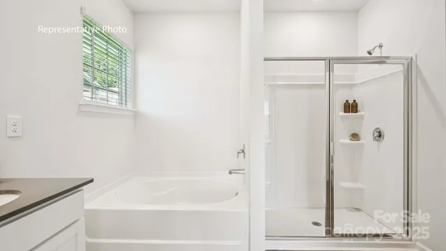 a bathroom with a granite countertop bathtub shower and sink