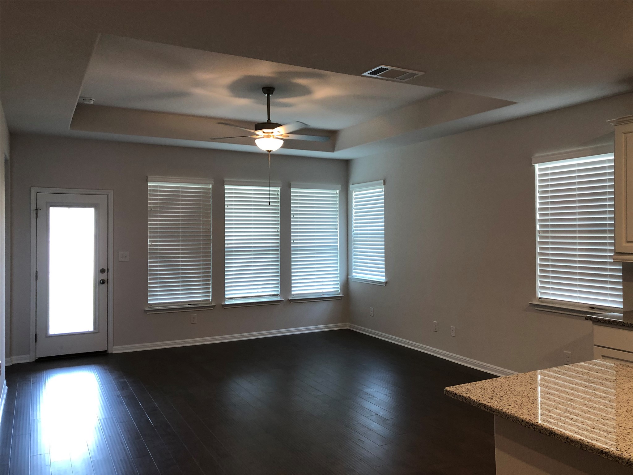 2746 Fortezza Way Round Rock, TX 78665 - Photo 3 of 16 Gleaming hardwood floors and a recessed tray ceiling define this open living area.