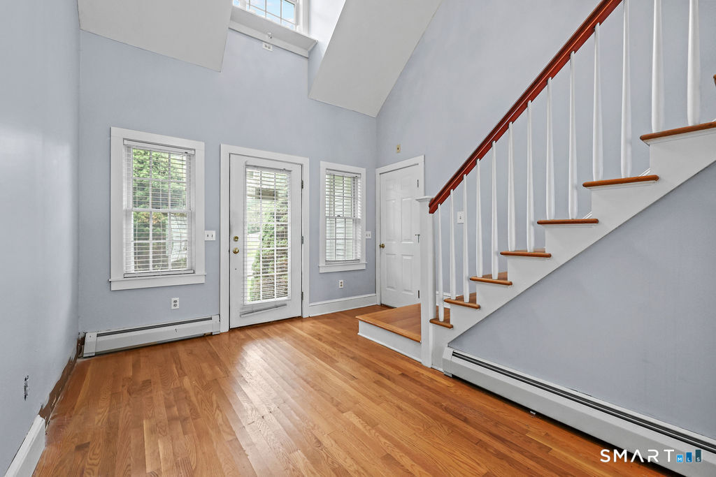 88 Powder Hill Road Middlefield, CT 06455 - Photo 11 of 40 a view of an empty room with wooden floor and fan