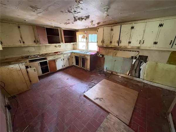a kitchen with stainless steel appliances granite countertop a stove sink and cabinets