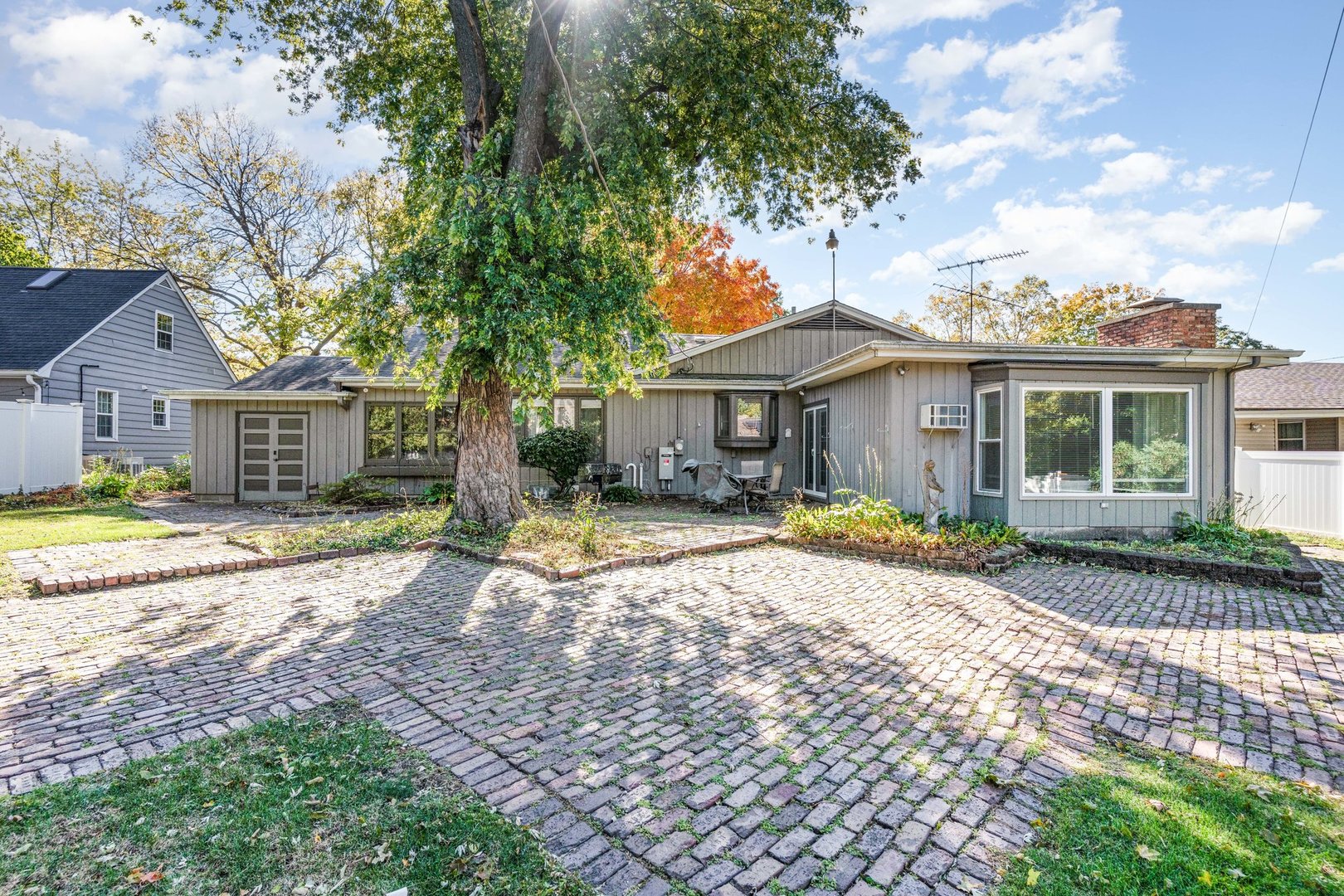1703 West Acres Road Joliet, IL 60435 - Photo 28 of 33 a front view of a house with a garden and trees