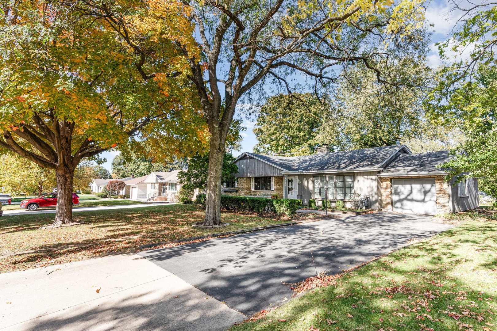 1703 West Acres Road Joliet, IL 60435 - Photo 32 of 33 a front view of a house with a yard and large trees