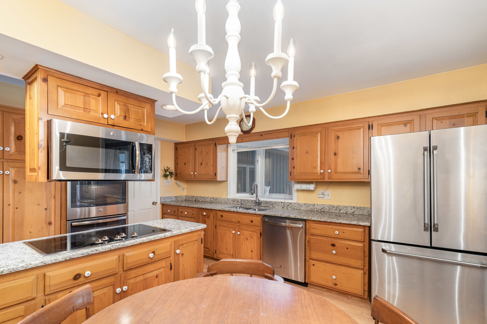 1703 West Acres Road Joliet, IL 60435 - Photo 10 of 33 a kitchen with stainless steel appliances granite countertop a refrigerator a stove and a sink with wooden floor