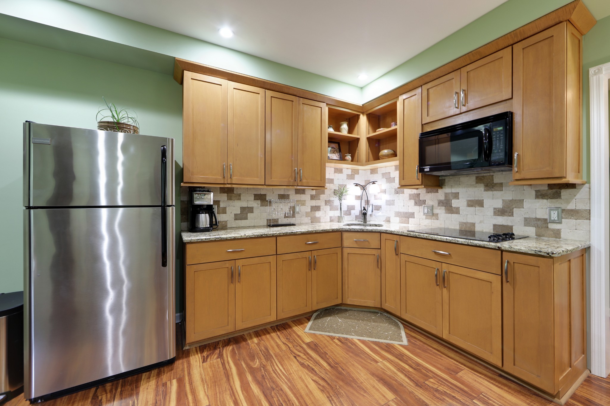 832 Rands Way Columbia, TN 38401 - Photo 32 of 49 a kitchen with stainless steel appliances granite countertop a refrigerator a microwave oven a sink dishwasher and white cabinets with wooden floor