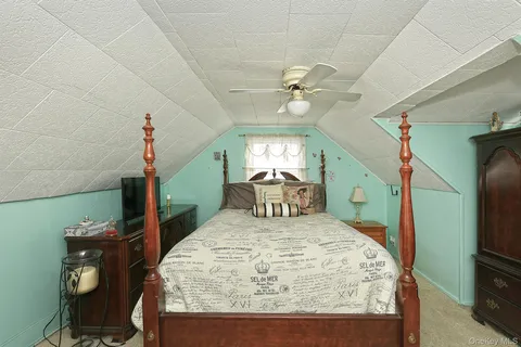 a bedroom with a bed a desk and chair