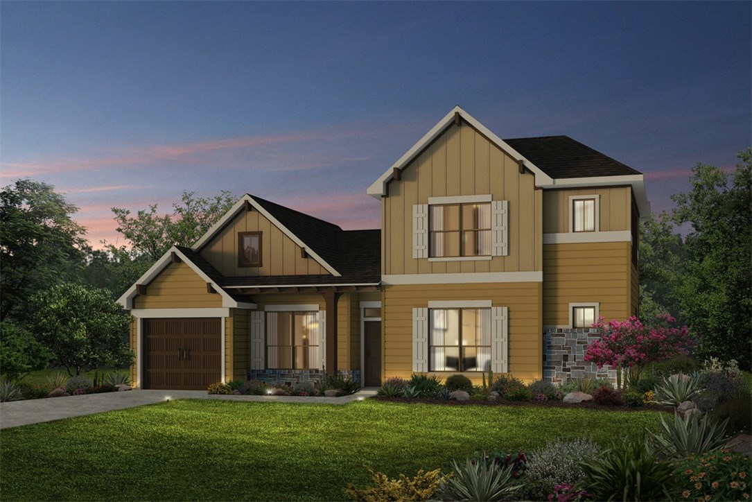 a front view of a house with a yard and trees