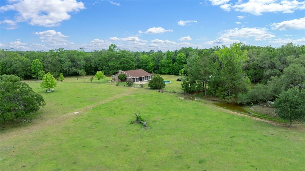 732 Carl Wilson Road Fort White, FL 32038 - Photo 67 of 80 a view of a big yard with lots of green space and mountain view