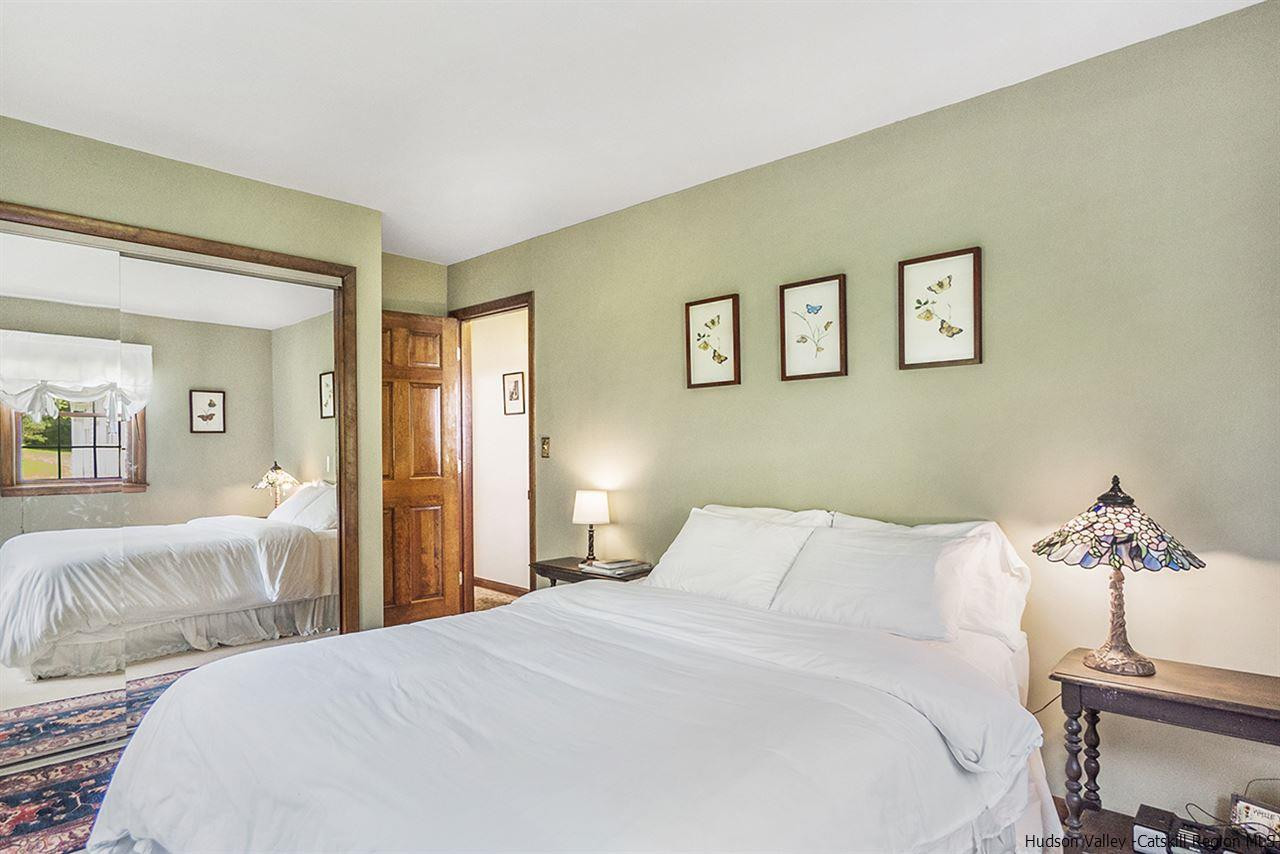 5999 Route 23c Route Prattsville, NY 12468 - Photo 21 of 31 a bedroom with a bed and a painting on the wall