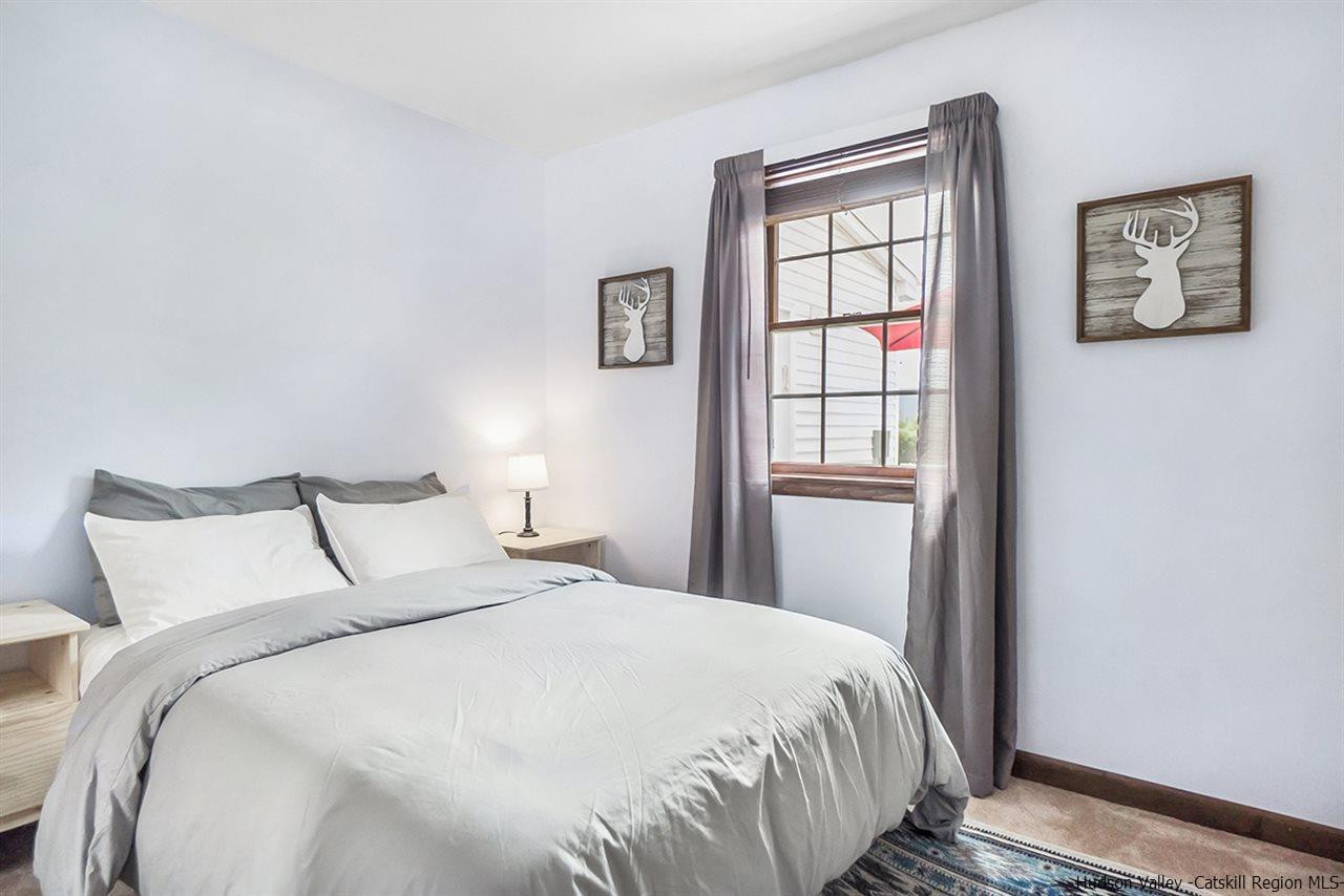 5999 Route 23c Route Prattsville, NY 12468 - Photo 22 of 31 a bedroom with a bed and a window