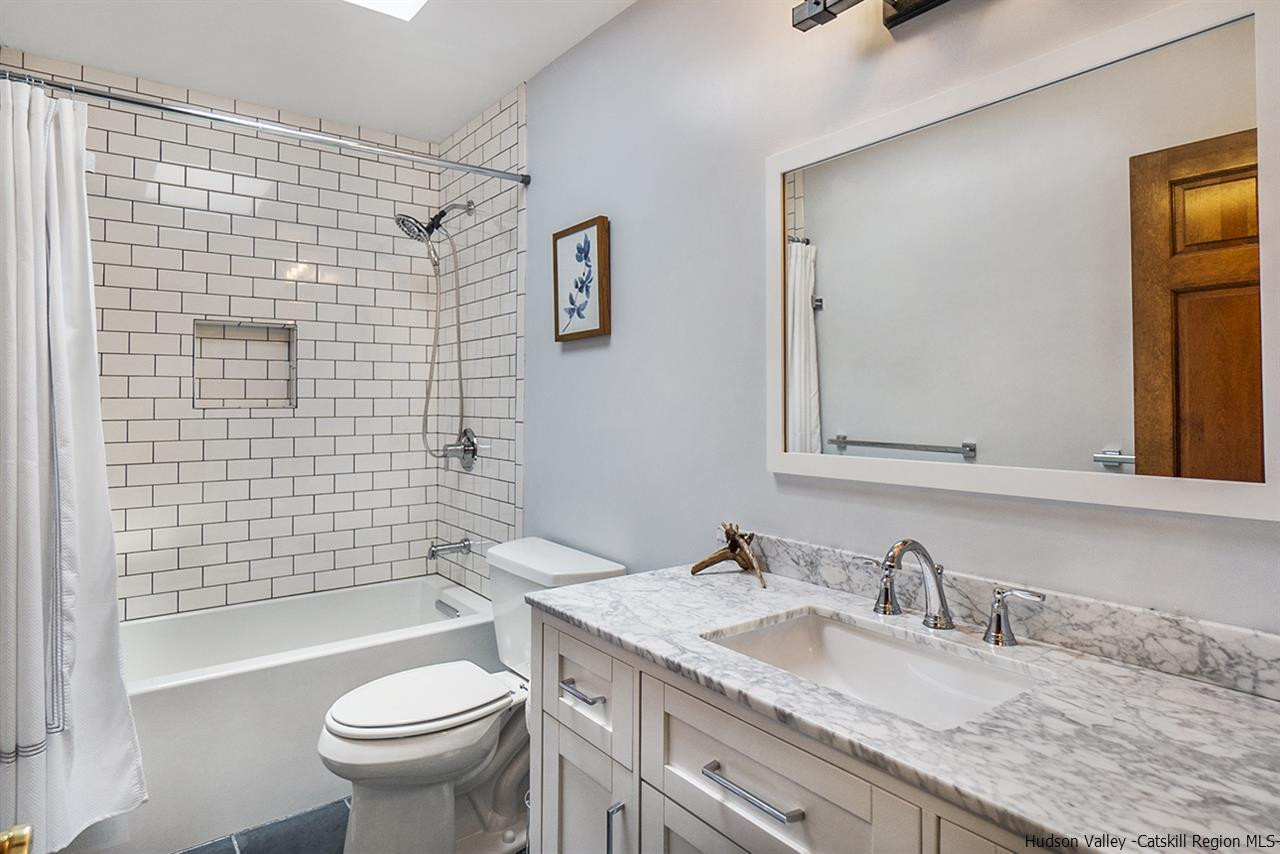 5999 Route 23c Route Prattsville, NY 12468 - Photo 24 of 31 a bathroom with a granite countertop toilet sink and mirror