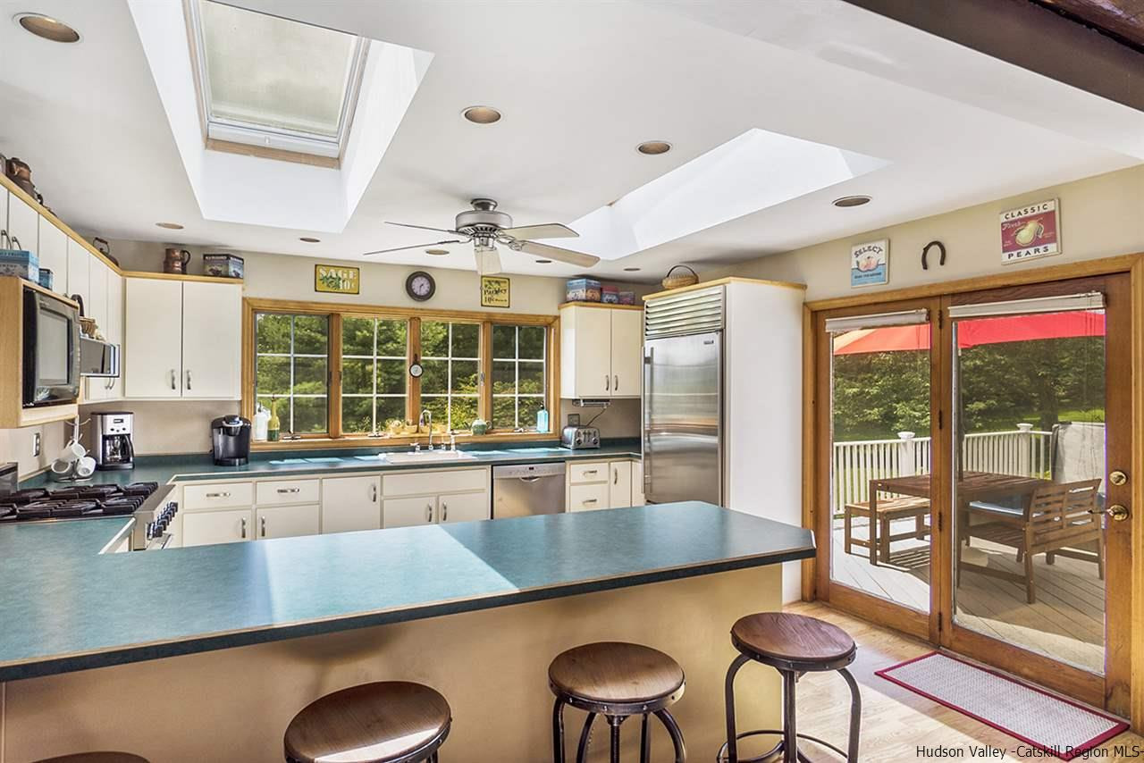 5999 Route 23c Route Prattsville, NY 12468 - Photo 4 of 31 a kitchen with stainless steel appliances granite countertop a stove and a view of living room
