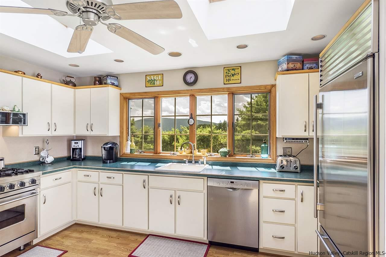 5999 Route 23c Route Prattsville, NY 12468 - Photo 5 of 31 a kitchen with granite countertop white cabinets white stainless steel appliances and a large window