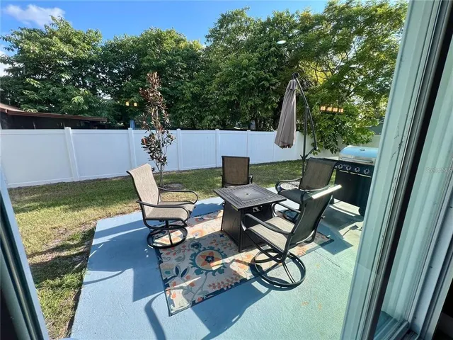 a patio with table and chairs