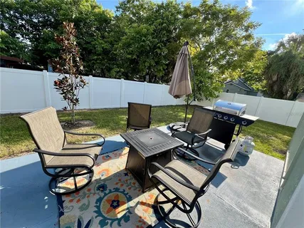 an outdoor sitting area with furniture and a table