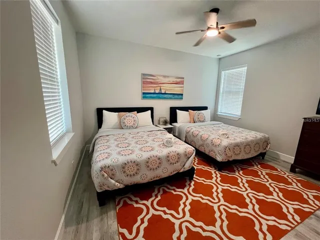 a bedroom with two beds and a window