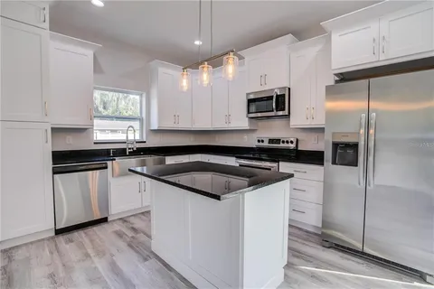 a kitchen with a sink stove and refrigerator