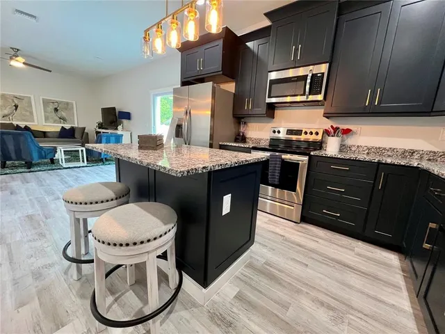 a kitchen with a stove sink and cabinets