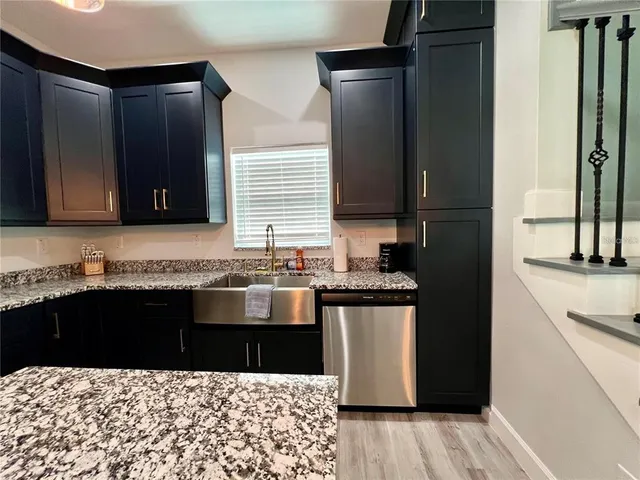 a kitchen with a sink and a refrigerator