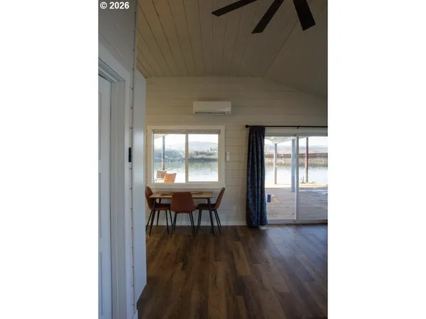 a dining room with furniture and wooden floor