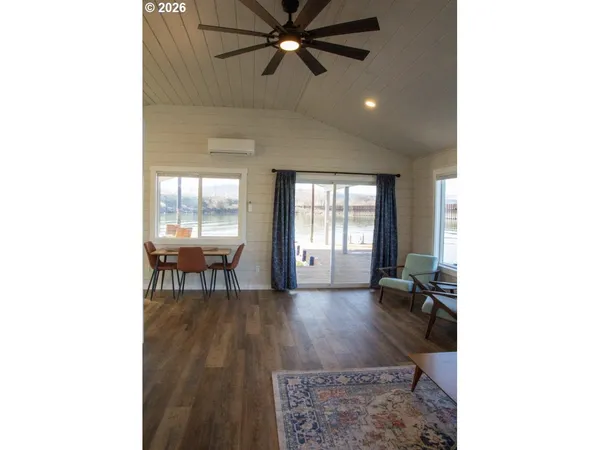 a living room with furniture and window with wooden floor
