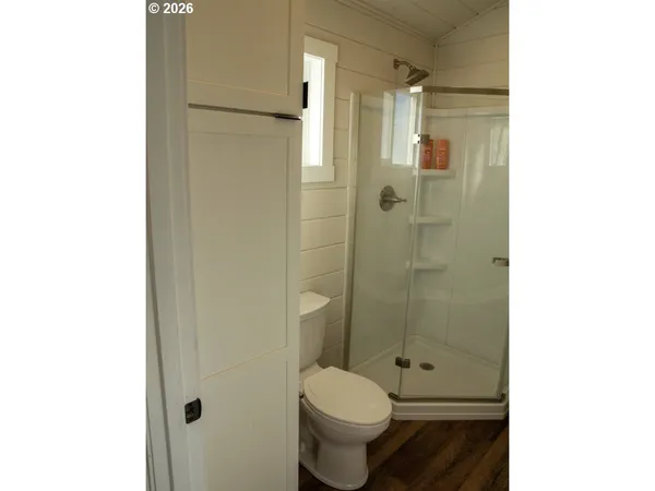 a bathroom with a granite countertop toilet and a shower