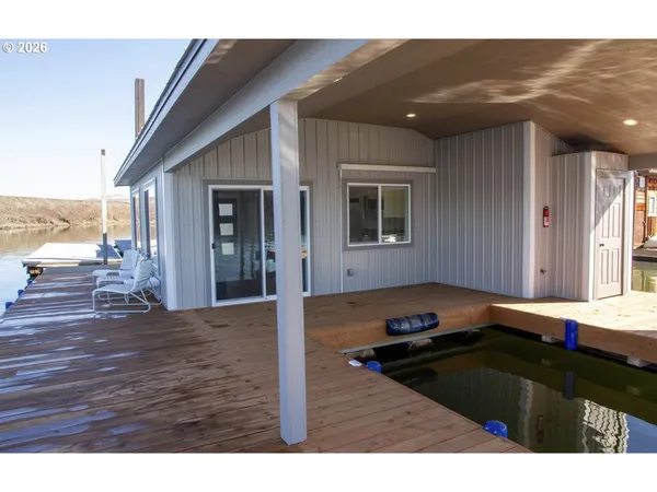 a kitchen view with wooden cabinets and outdoor space