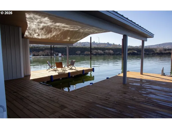 a living room with floor to ceiling window and wooden floor