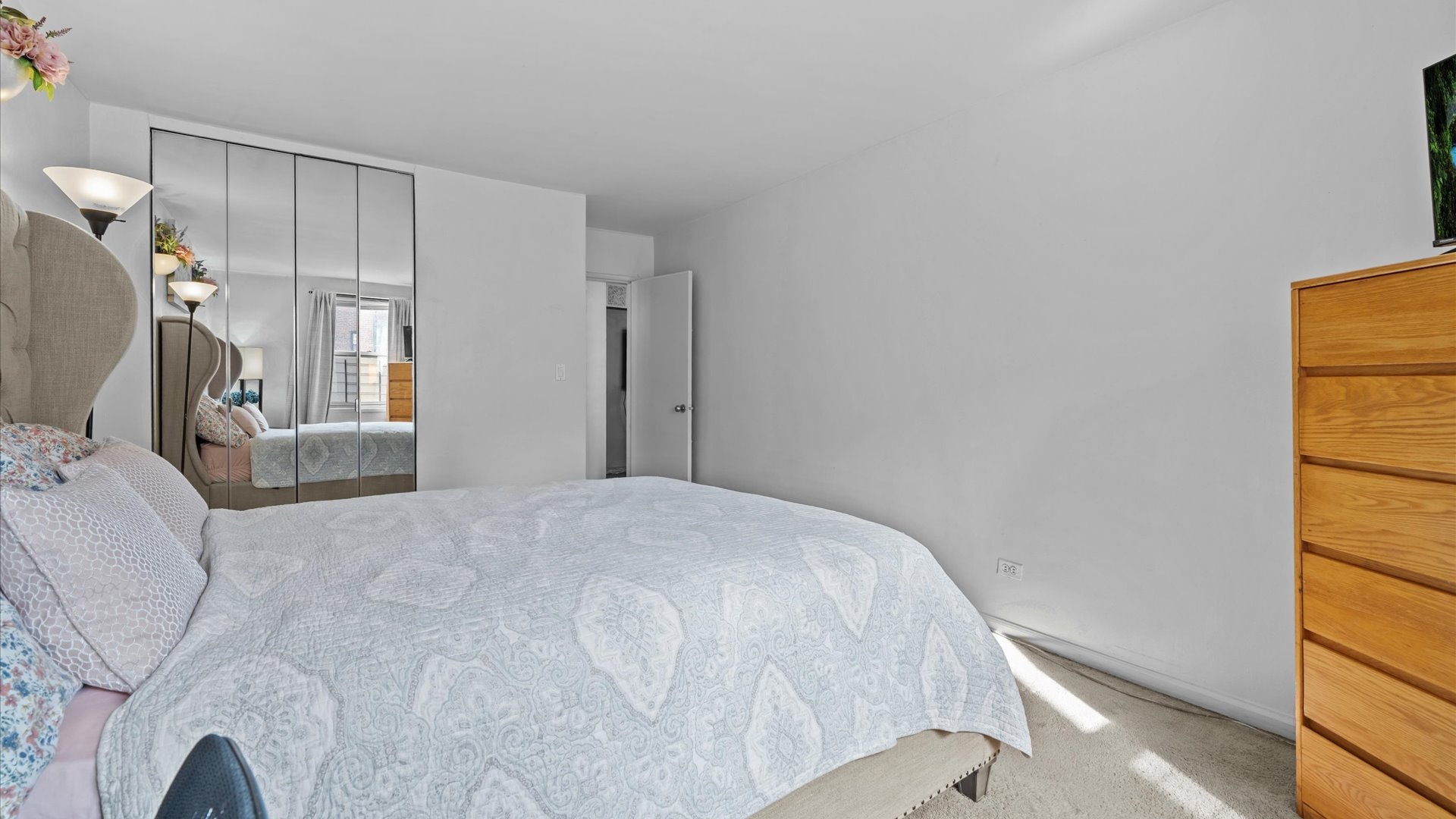 3520 Tryon Avenue, Unit 502 Bronx, NY 10467 - Photo 11 of 13 a bedroom with a bed and a window