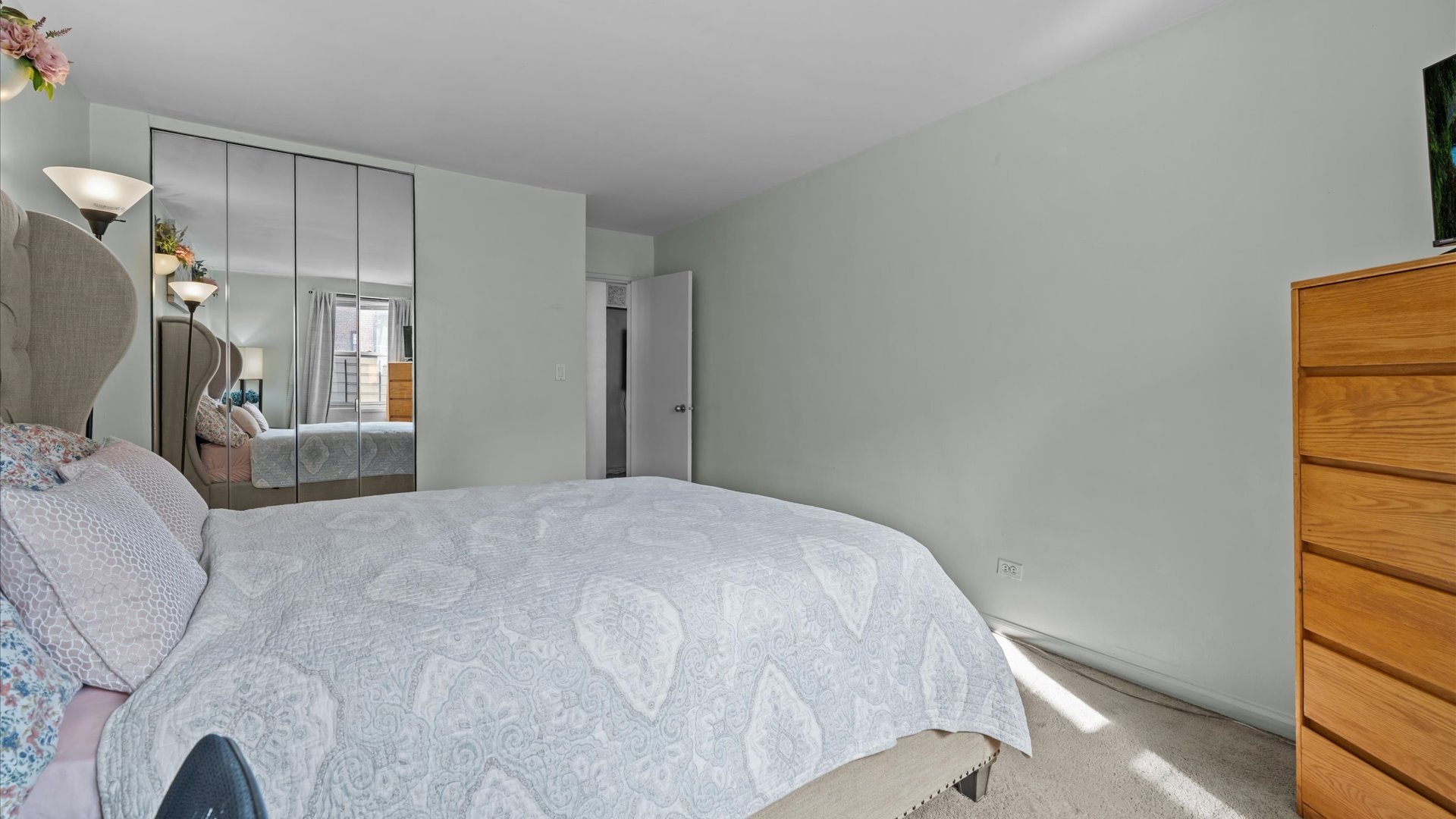 3520 Tryon Avenue, Unit 502 Bronx, NY 10467 - Photo 9 of 13 a bedroom with a bed and a window
