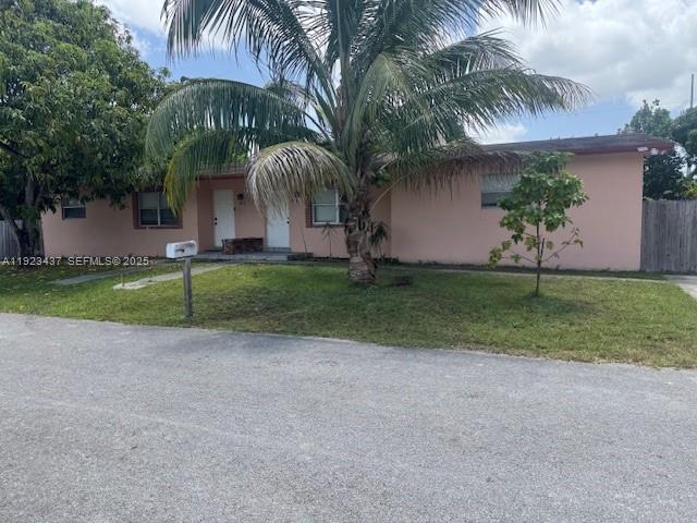 1910 Southwest 99th Avenue, Unit 1 Miramar, FL 33025 - Photo 1 of 17 a view of a house with a yard and palm trees