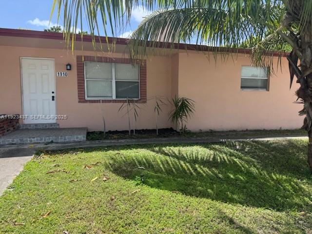 1910 Southwest 99th Avenue, Unit 1 Miramar, FL 33025 - Photo 3 of 17 a front view of a house with a yard