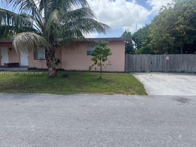 1910 Southwest 99th Avenue, Unit 1 Miramar, FL 33025 - Photo 4 of 17 a view of a house with a yard and a palm tree