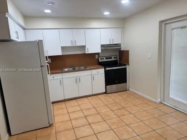 a kitchen with a sink and a refrigerator