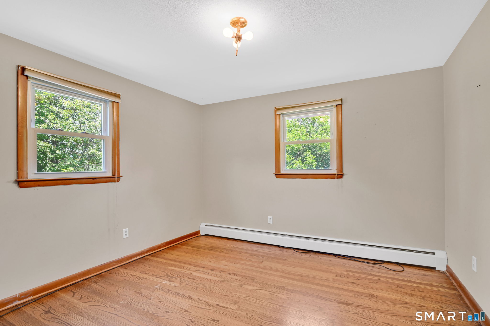 7 Rogers Drive Meriden, CT 06450 - Photo 22 of 40 a view of an empty room with wooden floor and a window