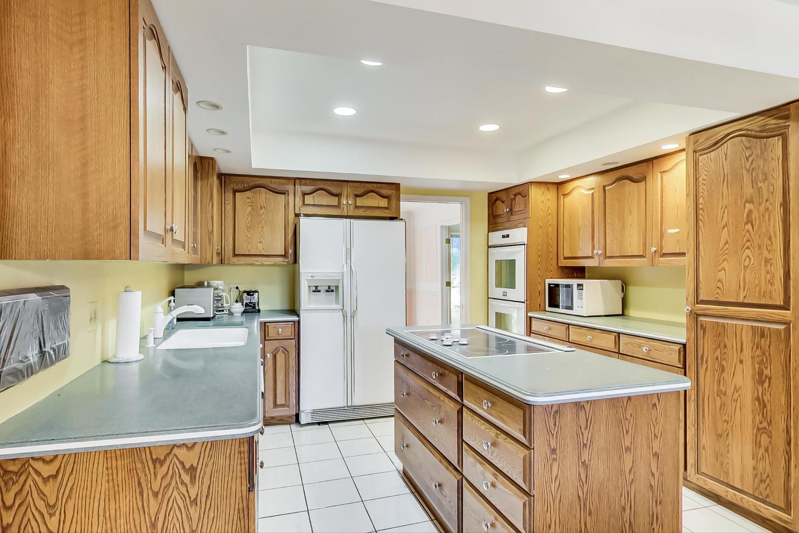 2813 Meyers Road Oak Brook, IL 60523 - Photo 11 of 62 a kitchen with stainless steel appliances granite countertop a sink stove and refrigerator
